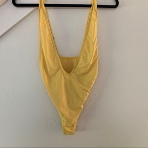 Yellow one piece swim suit.